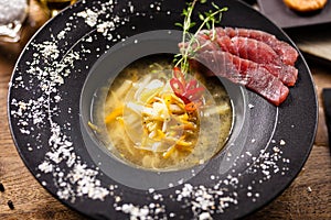 Clear Fish soup served in a bowl in restaurant