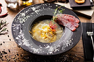 Clear Fish soup served in a bowl in restaurant