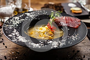 Clear Fish soup served in a bowl in restaurant