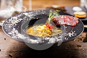Clear Fish soup served in a bowl in restaurant