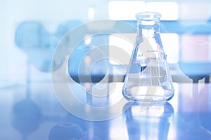 Clear flask with chemistry molecular in science laboratory background