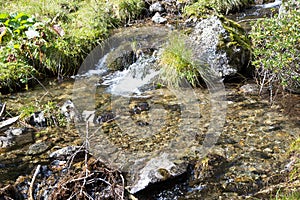 Clear fresh mountain water over stones photo