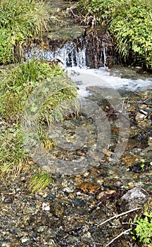 Clear fresh mountain water over stones photo