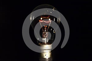 Clear glass electric lightbulb dimmed