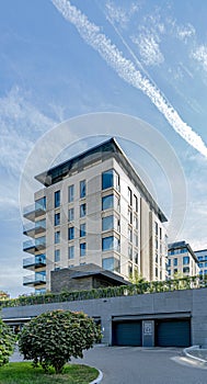 Corner of a building with beige cladding against a clear sky photo