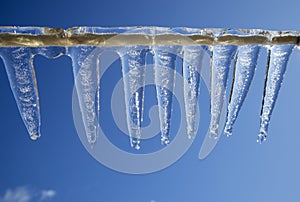 Clear icicles against blue sky