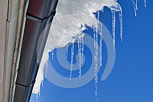 Clear icicles hanging from the roof