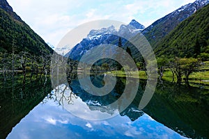 Clear lake with the reflection of the Siguniang mountain in Sichuan, China