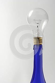 A clear light bulb on blue oil bottle