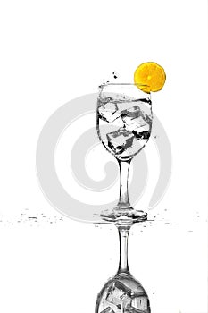 Clear liquid and Ice Cubes and lemon