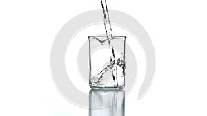 Clear liquid pouring into beaker