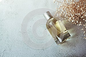 Clear perfume bottle with copy space. Fragrance with tiny flowers on white background