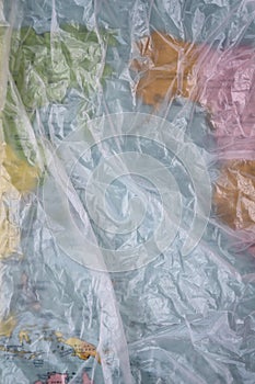 Clear plastic bag texture background. Earth map. Waste recycling concept. Crumpled polyethylene and cellophane.