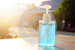 A clear plastic bottle containing a blue alcohol gel for hand cleaning to prevent coronavirus and other infections.