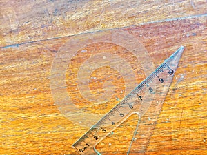 clear plastic ruler on a wooden table