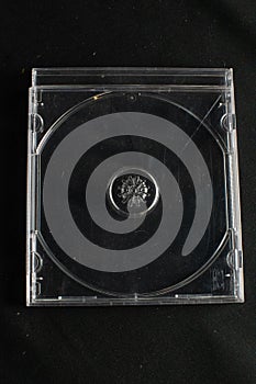 Clear retro CD cases with no Compact Discs against a black background