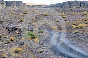 Clear road in Moroccan desert. Nobody. Mountains on horizon