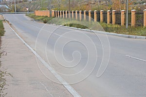 A clear road near a fence