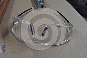 Clear Safety Glasses on Work Bench in Workshop
