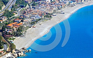 Clear sea, hotels and pebbly beach near Mazzeo Messina on east coast of island of Sicily, Italy