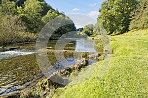 The clear, shallow River Lathkill in Lathkill Dale Derbyshire