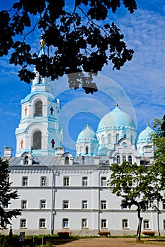 A clear sky with beautiful, white clouds above blue domes of the Transfiguration of Valaam Cathedral. Valaam is a cozy and