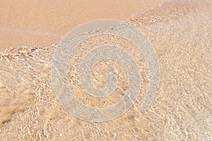 Clear soft wave of sea or ocean on sandy beach. Background