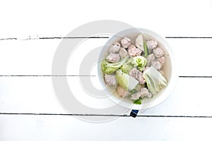 Clear Soup with Bean Curd and Minced Pork on white wooden background