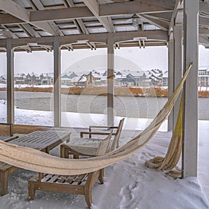 Clear Square Clubhouse overlooking Oquirrh Lake in winter day