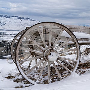 Clear Square Wooden cart on a hill with a view of snow capped mountain and cloud filled sky