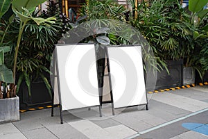 Clear street signage board placed by an outdoor dinning area of a restaurant.