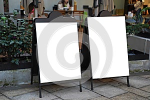 Clear street signage board placed by an outdoor dinning area of a restaurant.