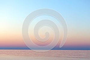 Clear sunset sky. Gradient background in pastel colors. Sunset over the sea.