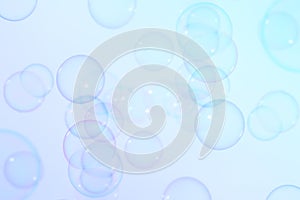 Clear transparent blue soap bubbles float background.