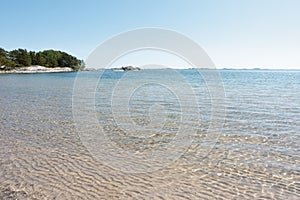 Clear turquoise water by paradise sand beach in Sandhamn, Stockholm archipelago in summer photo