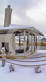 Clear Vertical Clubhouse overlooking lake and homes against cloudy sky on a frosty winter day