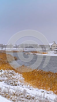 Clear Vertical Daybreak homes around Oquirrh Lake seen in winter