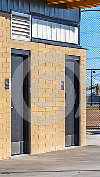 Clear Vertical Exterior of the public restrooms at a park viewed on a sunny day