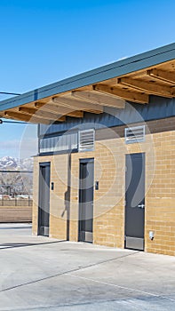 Clear Vertical Public restrooms with security camera installed beneath the flat roof