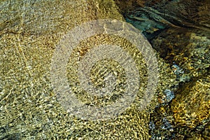 Clear water background.River stream. Big stone under clear water of river.Water background.Summer