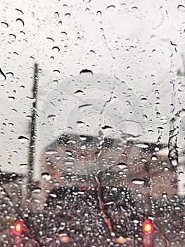 Clear water droplets on the windshield of the car after the rain