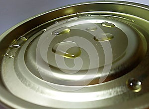 Clear water drops over the lid of the can