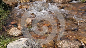 Clear water flow, rocky river closeup. Flowing water of creek in mountain valley