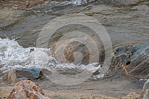 Clear water flowing over colourful rocks, Cornwall