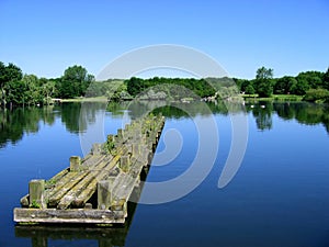 Clear water with sky and pier