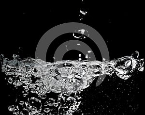 Clear water surface on a black with ripple and bubbles
