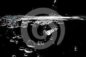 Clear water surface on a black with ripple and bubbles photo