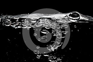 Clear water surface on a black with ripple and bubbles photo