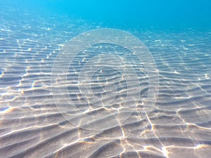 Clear water. underwater background with sandy sea bottom. Beautiful texture of the sea and ocean water