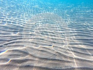 Clear water. underwater background with sandy sea bottom. Beautiful texture of the sea and ocean water